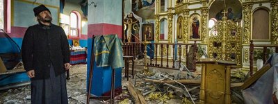 The priest of the village of Yasnohorodka, near Kyiv, stands inside his destroyed church
