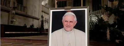 A portrait of Pope Emeritus Benedict XVI is seen near the altar at the Cathedral of Regensburg, southern Germany on December 29, 2022, during a church service.