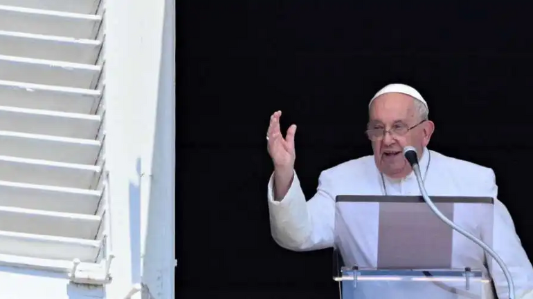 Pope Francis waves to the crowd from the window of The Apostolic Palace overlooking St. Peter's Square in The Vatican on July 14 during the weekly Angelus Prayer. - фото 1