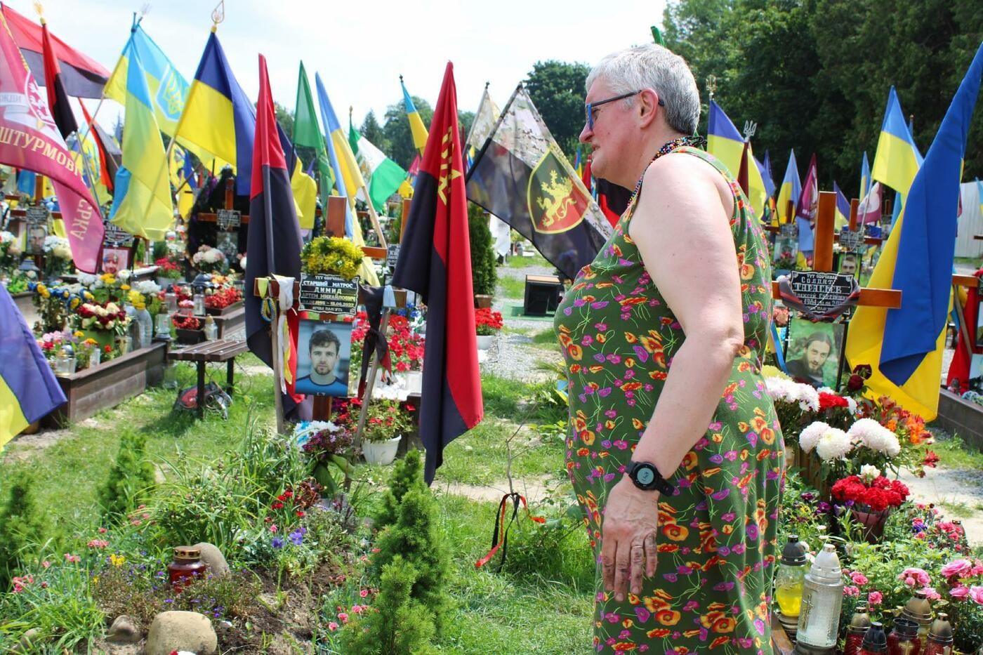 Ukrainian iconographer and artist Ivanka Krypyakevych-Dymyd, seen June 23, 2023, tends the grave of her son, Artem, who was killed in June 2022 while defending Ukraine and was laid to rest in the military cemetery in Lviv, Ukraine. - фото 122187